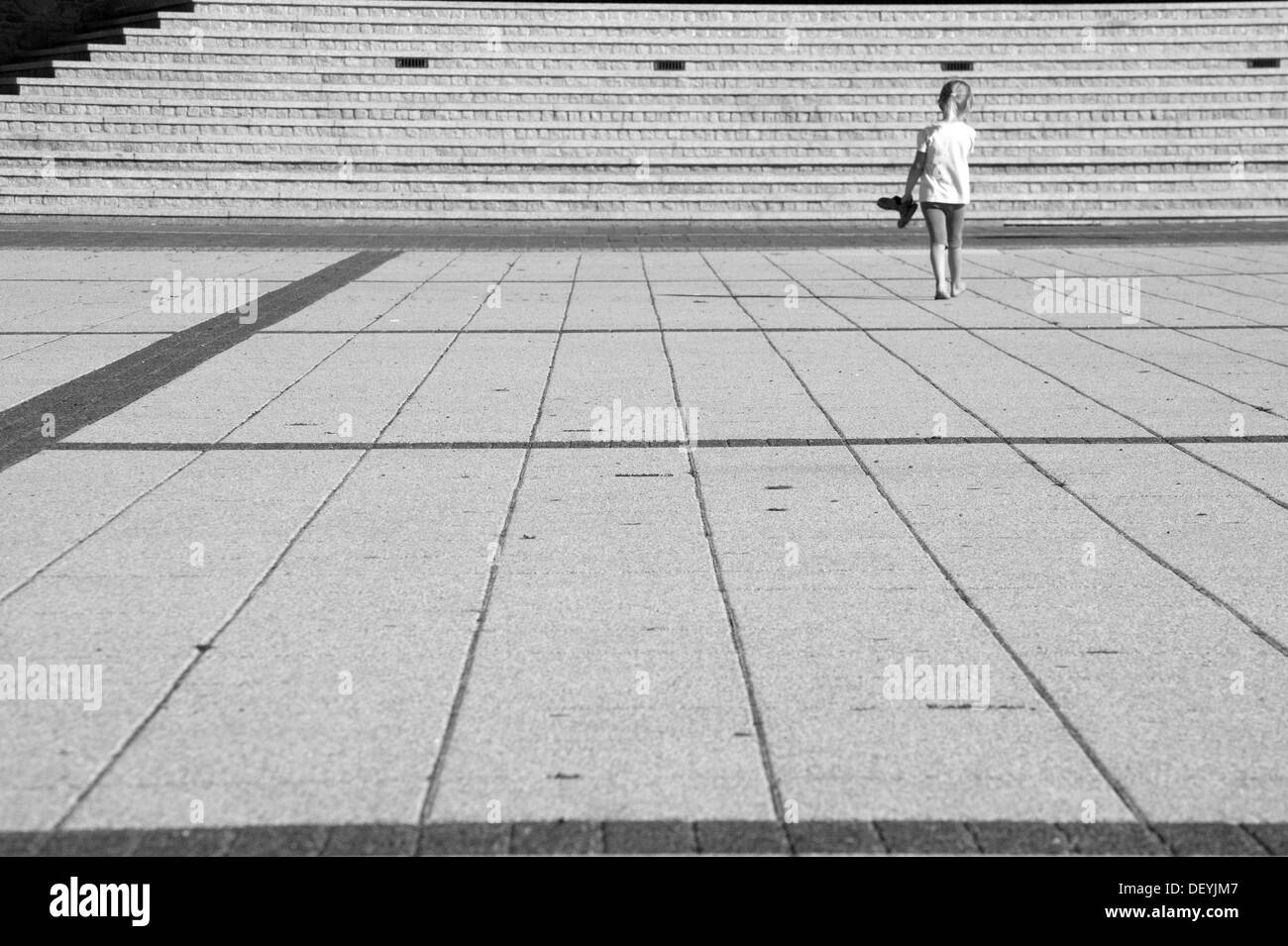 Girl walking around the square Stock Photo