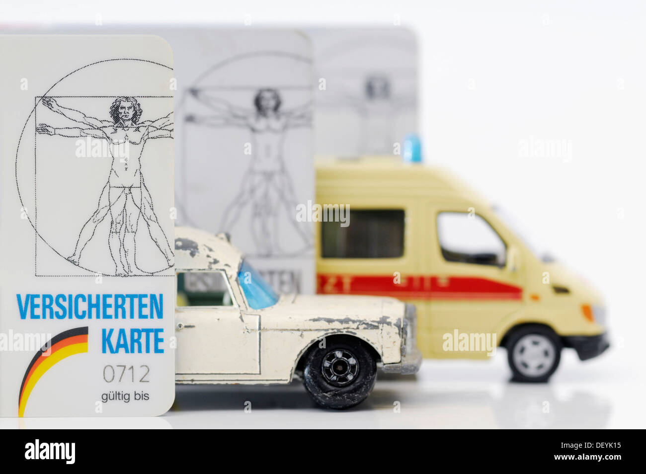Health Insurance Cards And Miniature Ambulances Symbolic Image For 