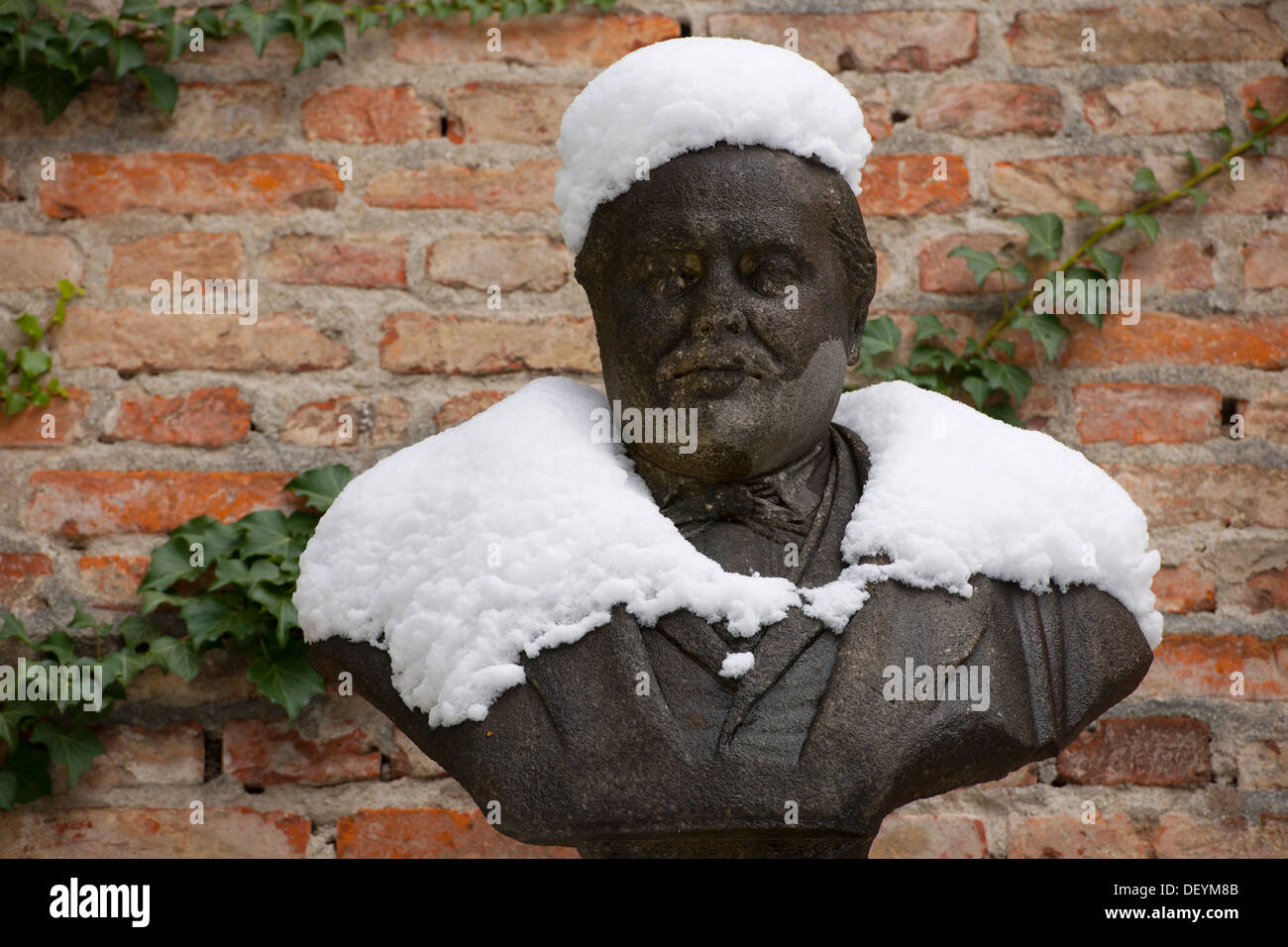 Bust covered with snow, Alter Suedlicher Friedhof cemetery, Munich, Bavaria Stock Photo