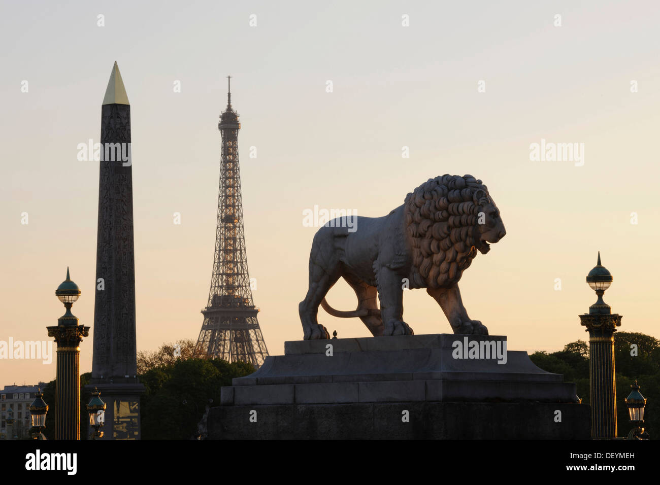 Lion sculpture and obelisk on the Place de la Concorde, Eiffel Tower, Tour Eiffel at back, Paris, Ile-de-France, France Stock Photo