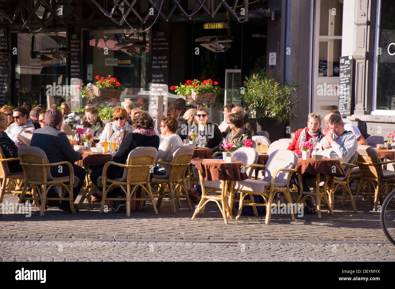 Customers sit outside Hotel de la Bourse restaurant cafe bar pub on Markt Maastricht Netherlands Stock Photo