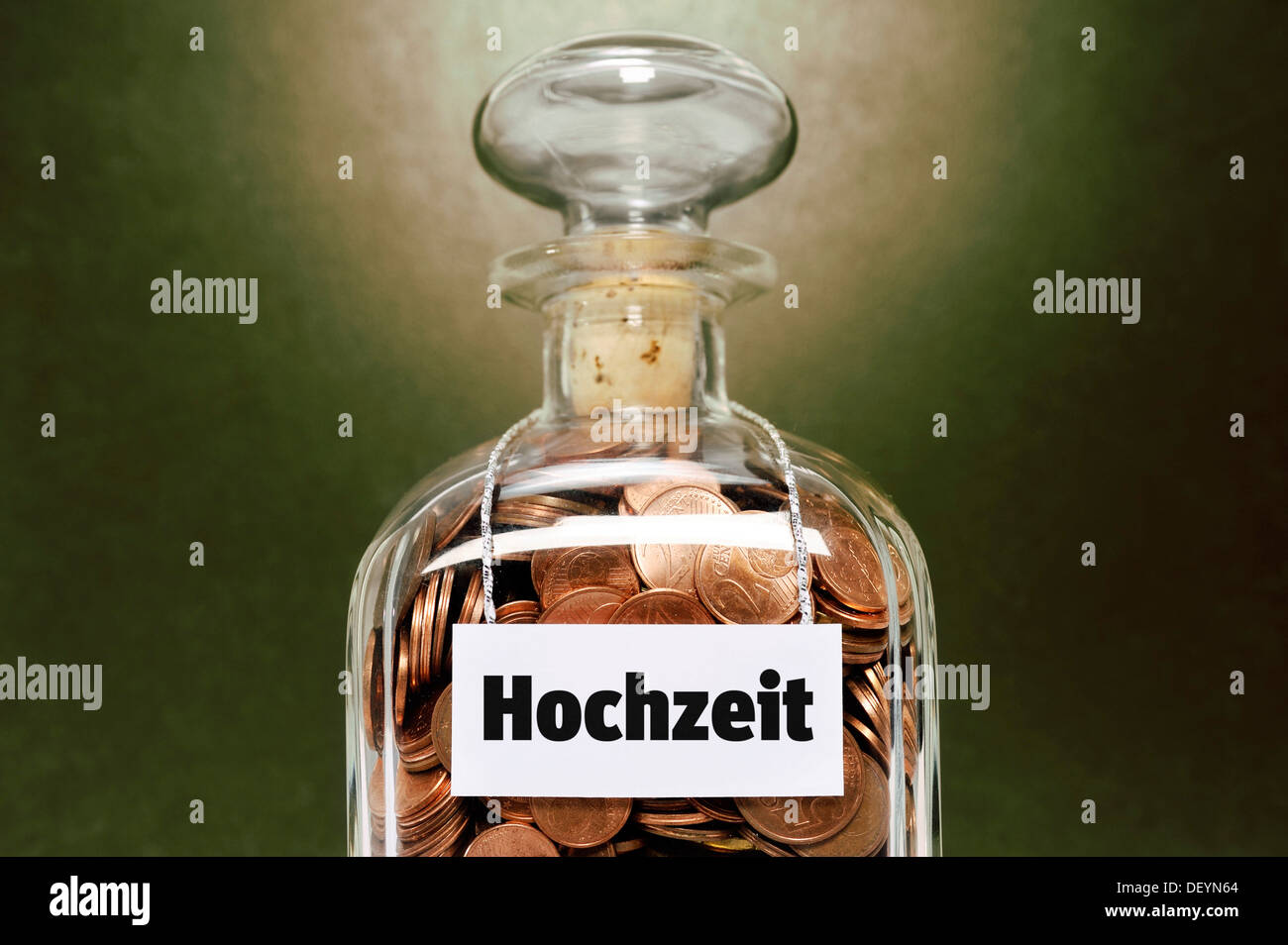 Glass jar filled with euro cent coins, labelled Hochzeit, German for