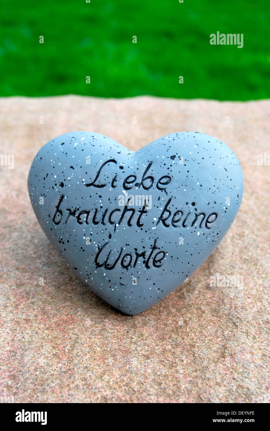 Liebe braucht keine Worte', German for love needs no words, written on heart Stock Photo