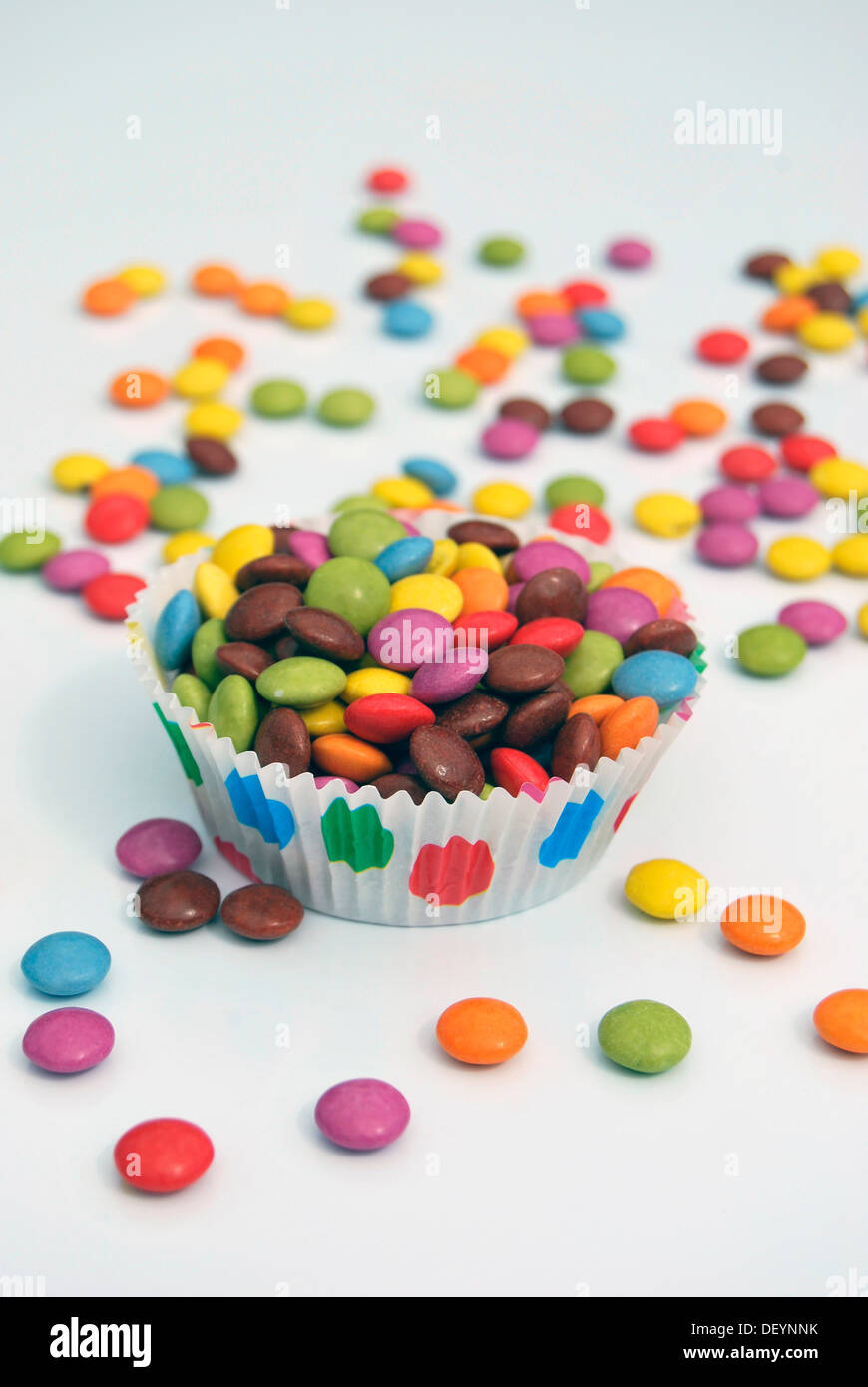 Many colourful Smarties in a muffin case Stock Photo
