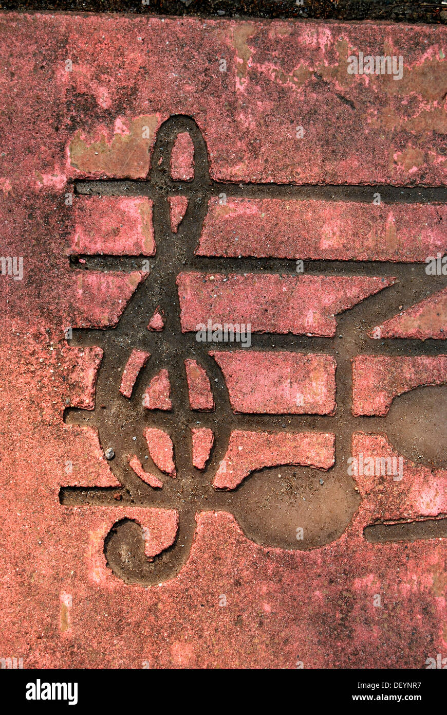 Clef with musical notes, paving slab, pavement Stock Photo