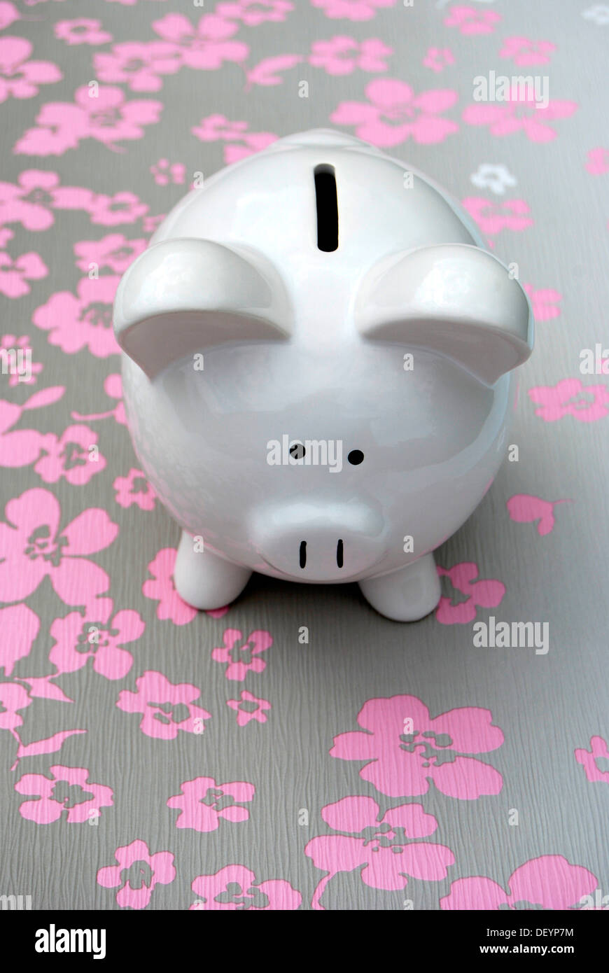 White piggy bank on flowery surface Stock Photo - Alamy