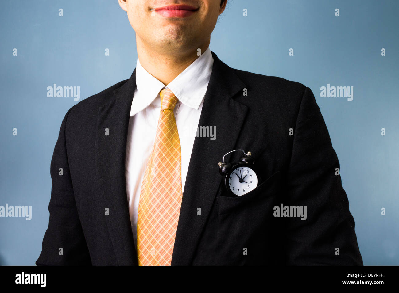 Young business man with a clock in his front pocket has time on his side Stock Photo