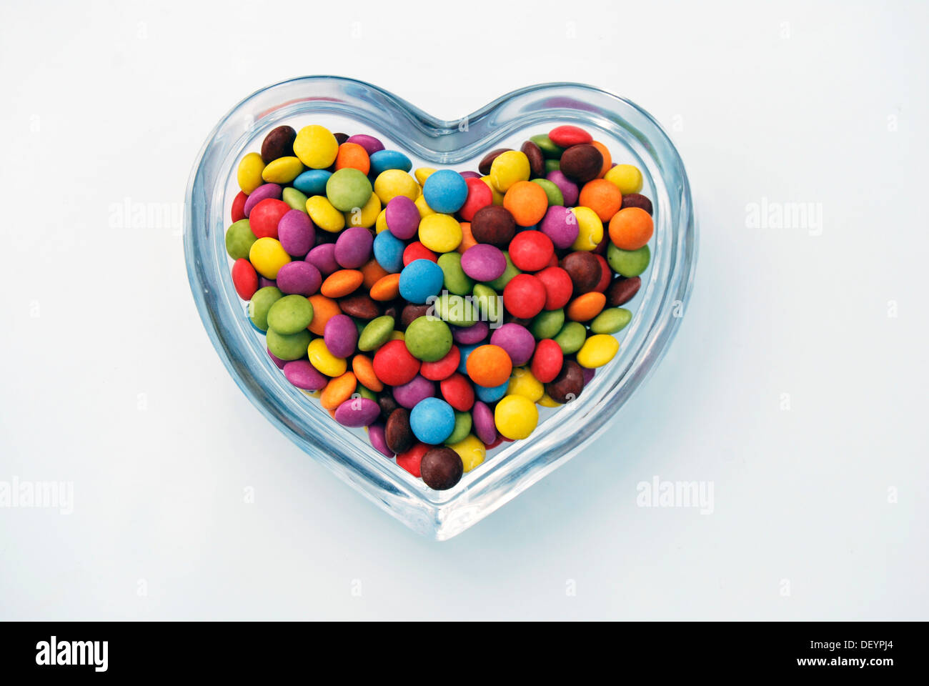 Smarties, chocolate candy, heartshaped shell glass bowl Stock Photo Alamy