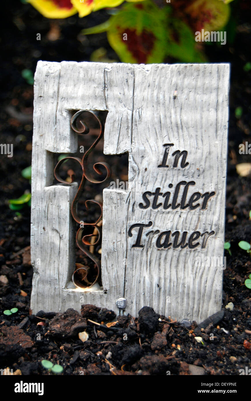 Wooden boad with text In stiller Trauer or in silent mourning, cross, grave, cemetery Stock Photo