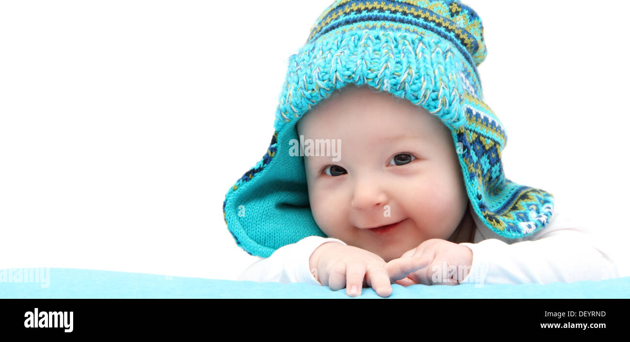 happy baby boy in knitted hat on stomach Stock Photo