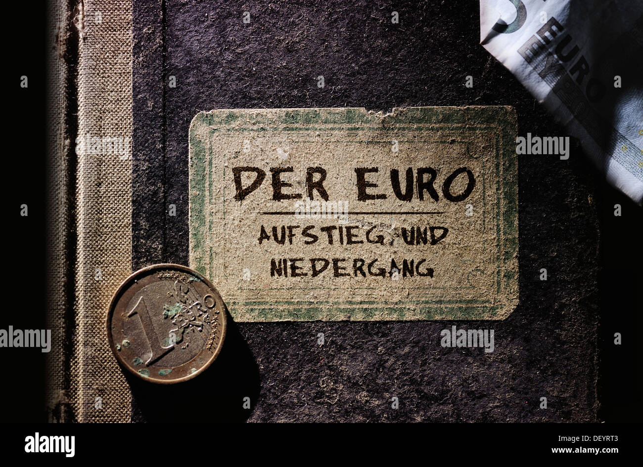 Old book with the inscription, Der Euro – Aufstieg und Niedergang, German for The euro – rise and fall, symbolic image for Stock Photo