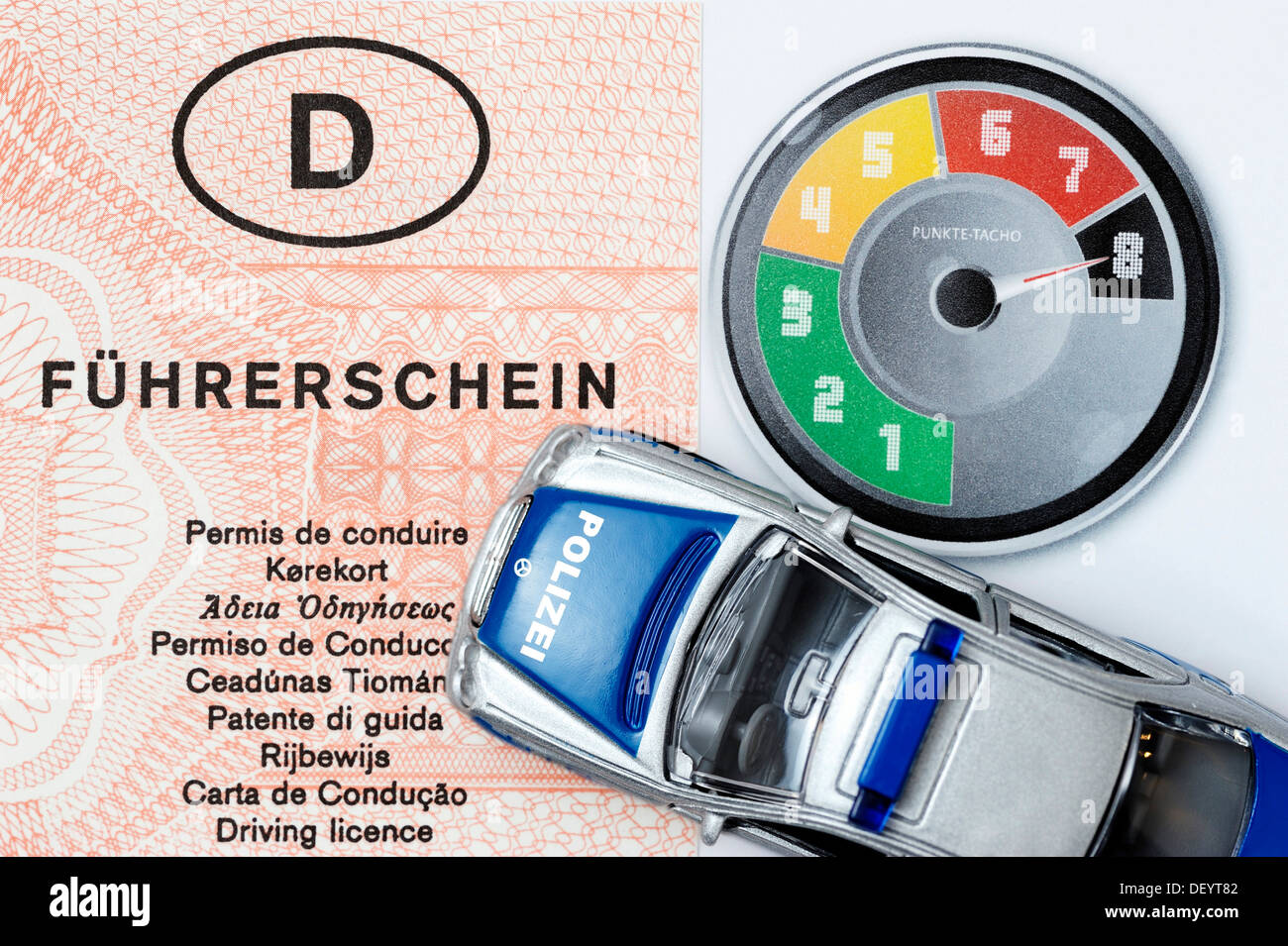 Miniature police car, driving license, speedometer with points
