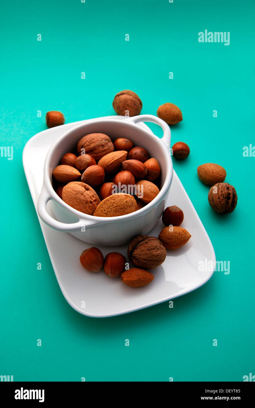 Soup bowl filled with various nuts, walnuts, almonds, hazelnuts Stock Photo