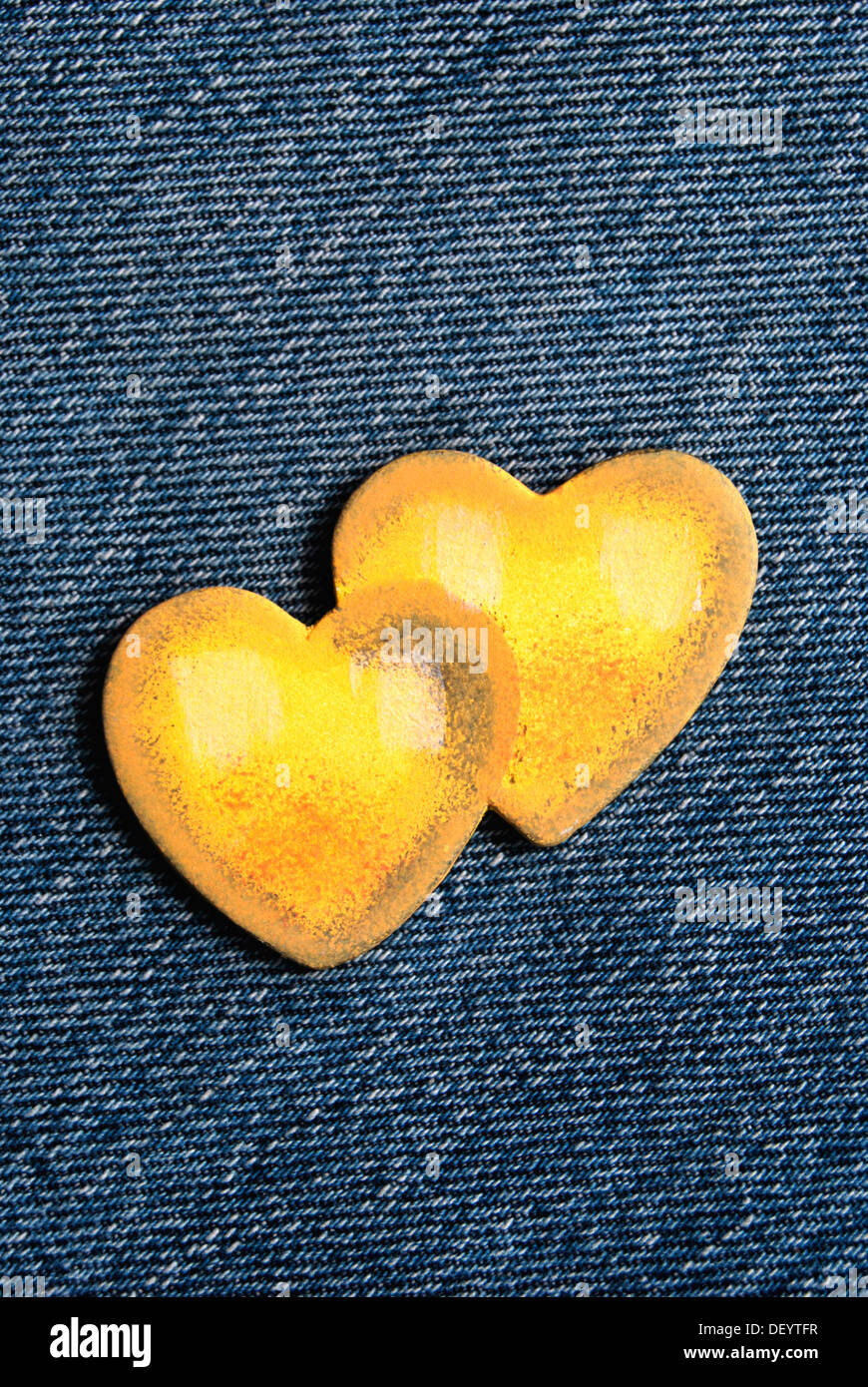 Two yellow hearts, denim Stock Photo