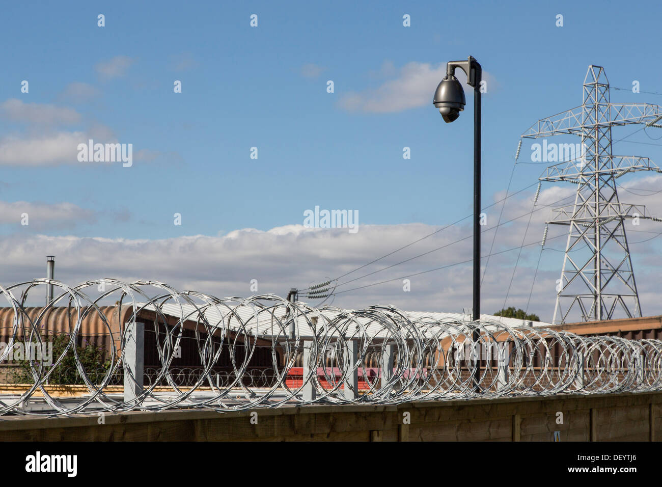 Razor Wire, Barbed wire, security fence, cctv, high security compound, wire coils, big brother is watching Stock Photo