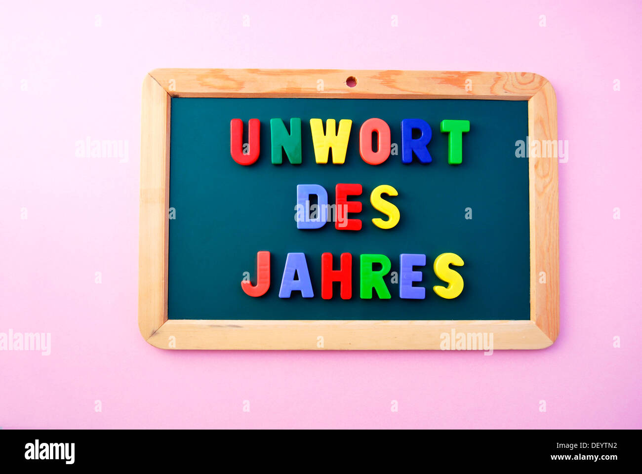 Unwort des Jahres, German for Worst Word of the Year, written in colourful magnetic letters on a school board Stock Photo