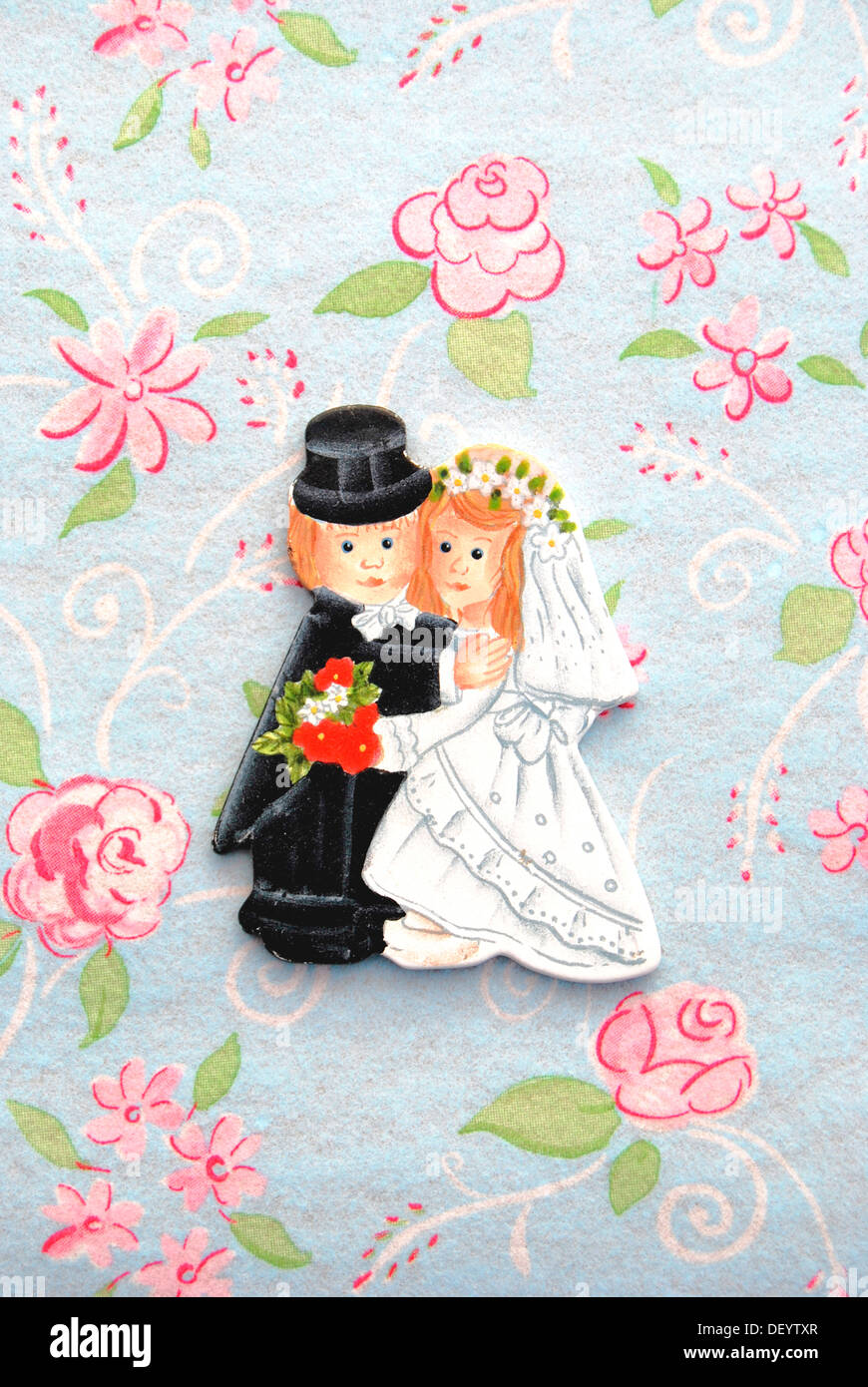 Bride and groom, table decorations on a floral tablecloth Stock Photo