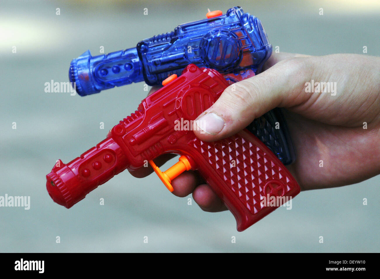 Two water guns in a hand Stock Photo Alamy
