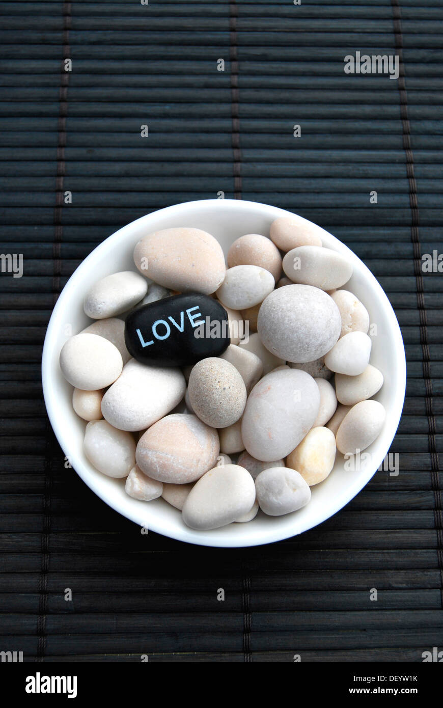 Hot stone massage stones with the inscription Love Stock Photo