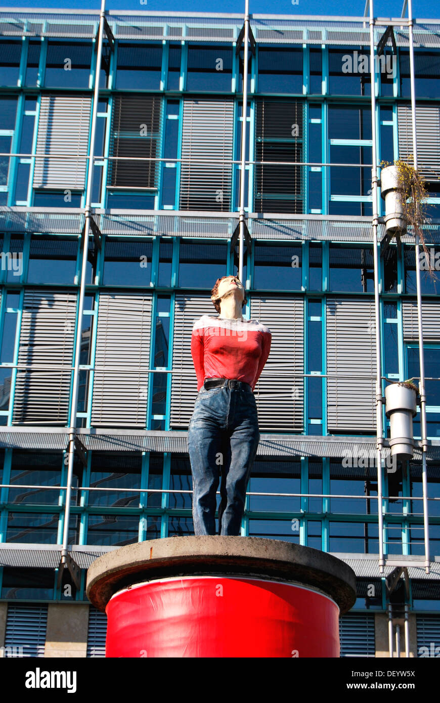 Woman looking up, sculpture on a red pillar pedestal, Duesseldorf, North Rhine-Westphalia Stock Photo