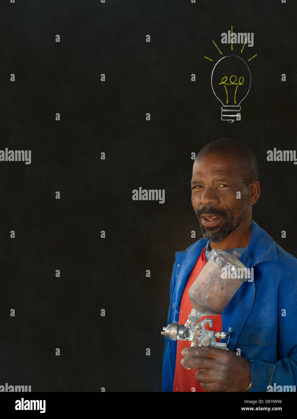 African American black man industrial worker with chalk light bulb on a blackboard background Stock Photo