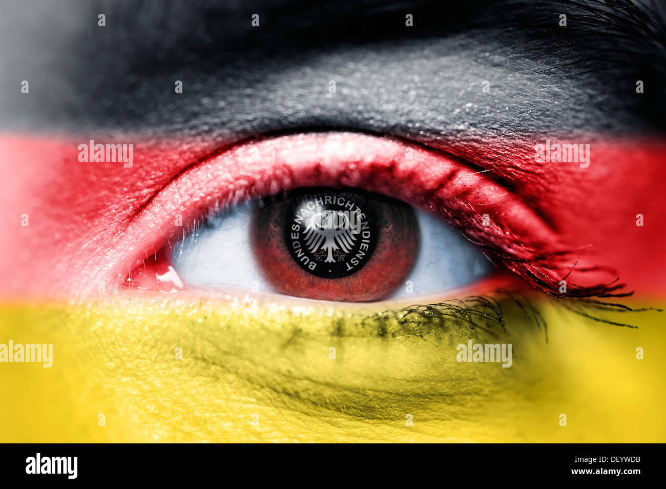 Federal Intelligence Service signs in the eye of a woman with German national colours, Ausspaehskandal, BND-Zeichen im Auge eine Stock Photo