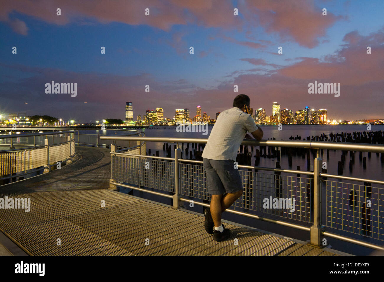 Man looking at the skyline, Hudson River Park, near Pier 45, Greenwich Village, Lower West Side, Manhattan, New York City, USA Stock Photo