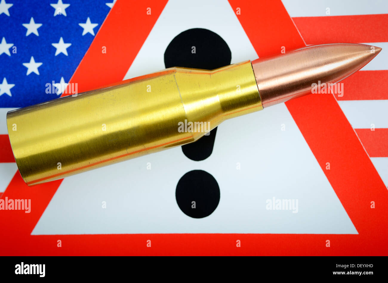 Cartridge on USA flag with danger sign, terror warning, Patrone auf USA-Fahne mit Gefahrenschild, Terrorwarnung Stock Photo