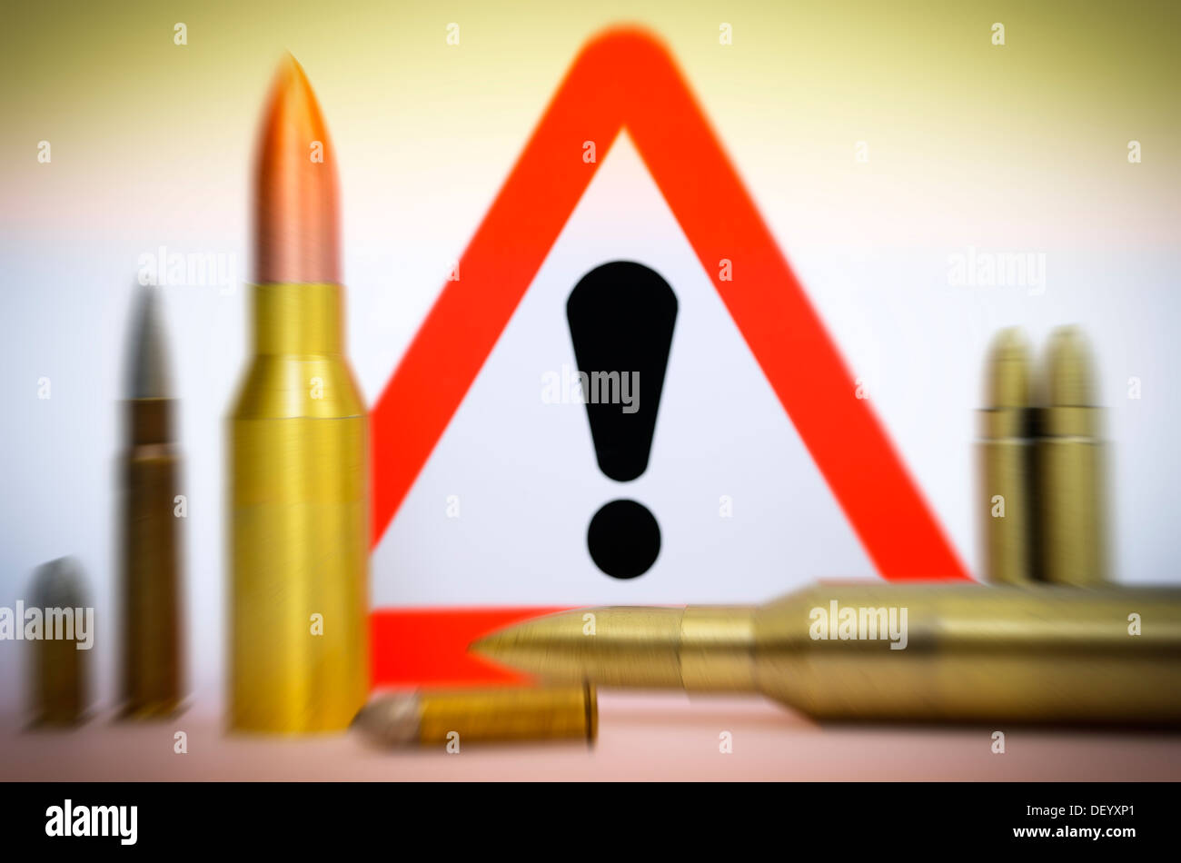 Cartridges before danger sign, terror warning, Patronen vor Gefahrenschild, Terrorwarnung Stock Photo