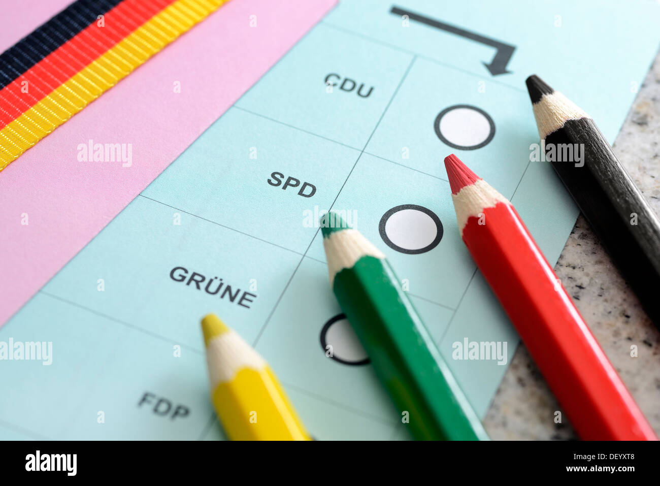 Four coloured pencils on an electoral slip of paper, parliamentary elections, Vier Buntstifte auf einem Wahlzettel, Bundestagswa Stock Photo