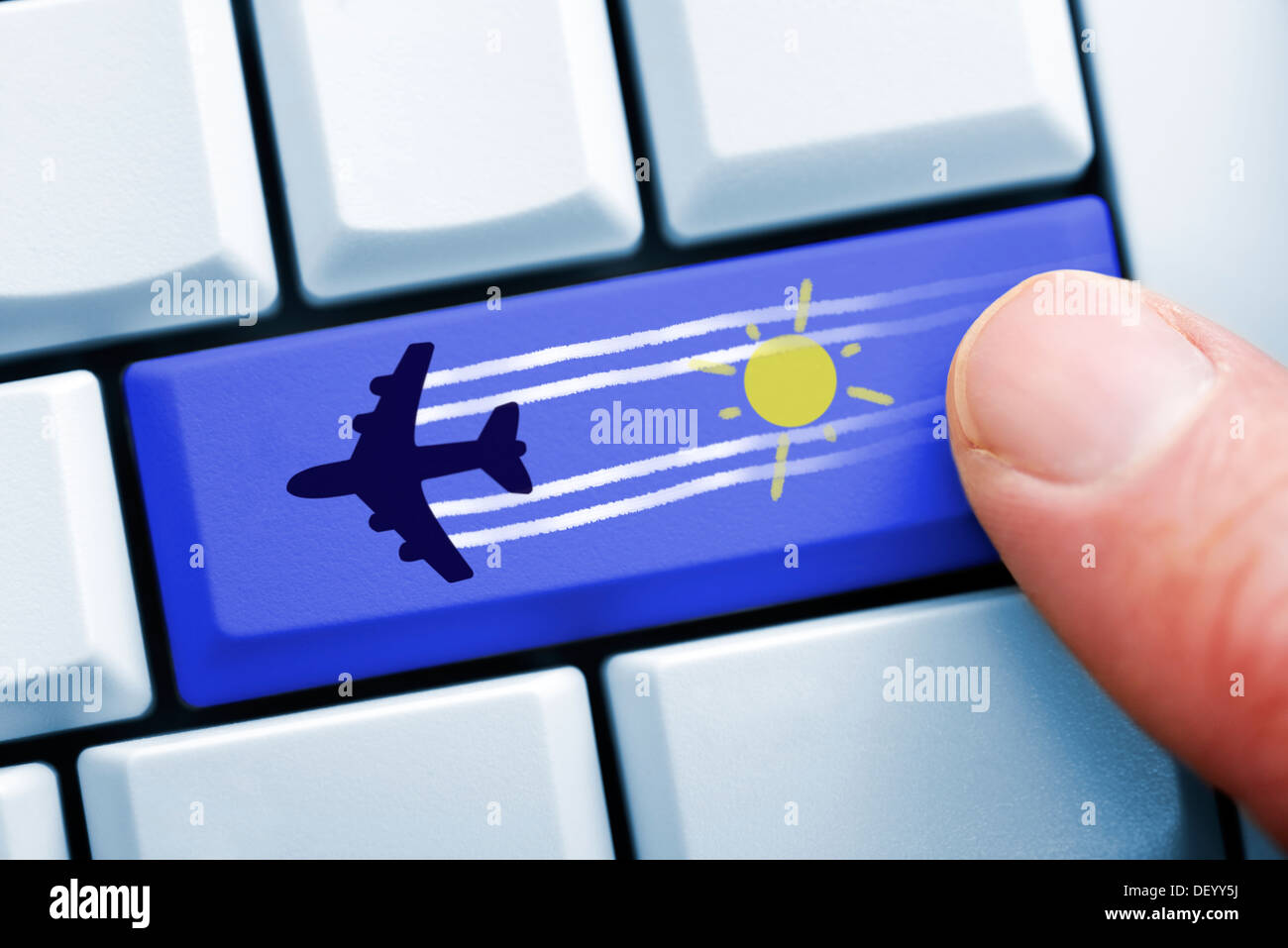 Finger on computer key with airplane symbol, on-line reservation of flights, Finger auf Computertaste mit Flugzeugsymbol, Online Stock Photo