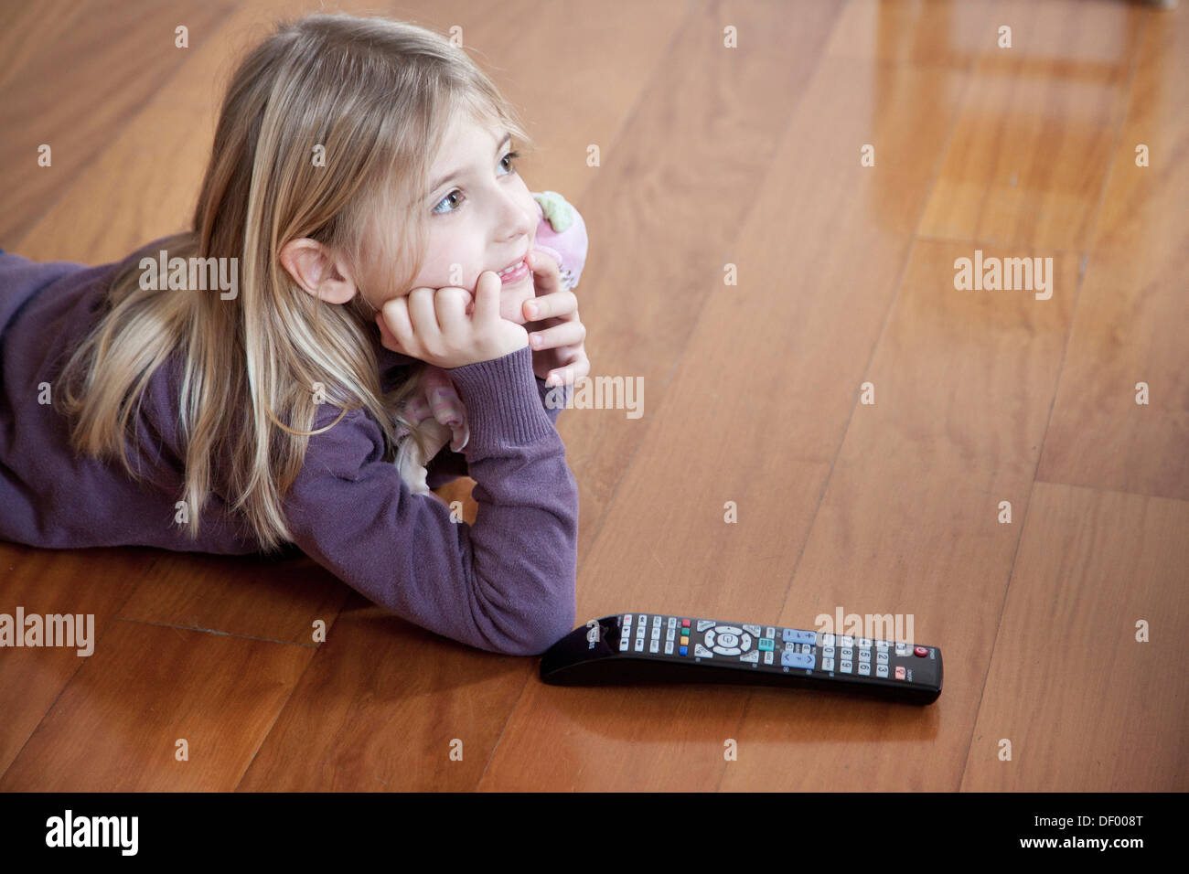 Girl watching TV at home Stock Photo Alamy