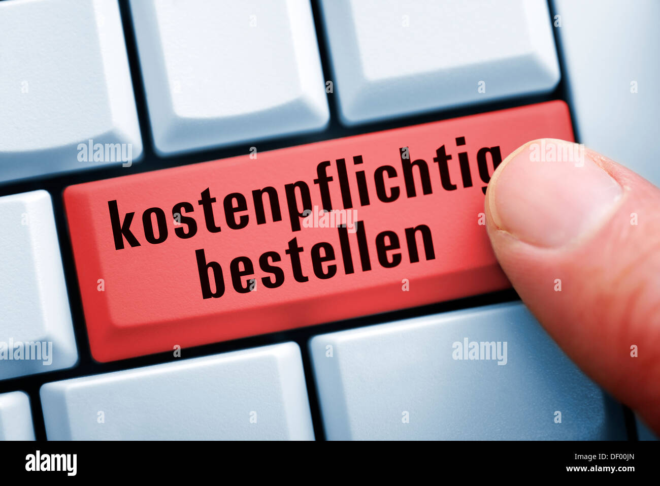 Finger on computer keyboard with ordering key, Finger auf Computertastatur mit Bestellen-Taste Stock Photo