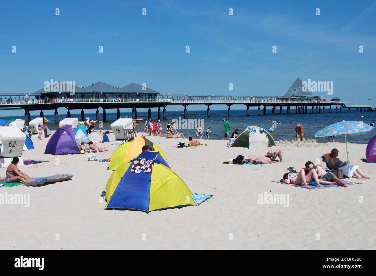 Tourists with beach tents on the beach in front of the pier, Heringsdorf, Mecklenburg-Western Pomerania, Germany Stock Photo