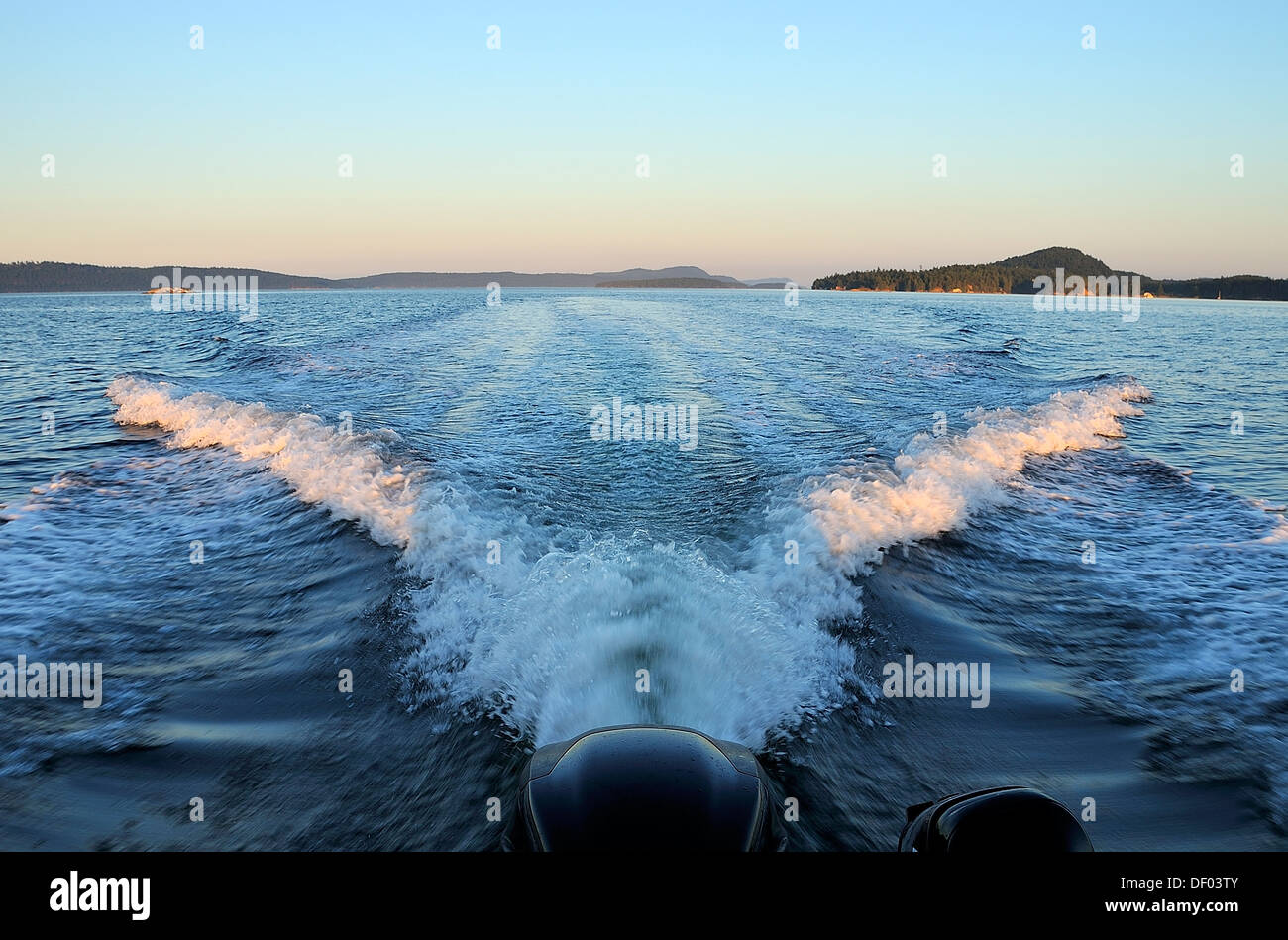 A v shaped wake from the boat makes an impressive scene in the water. Stock Photo
