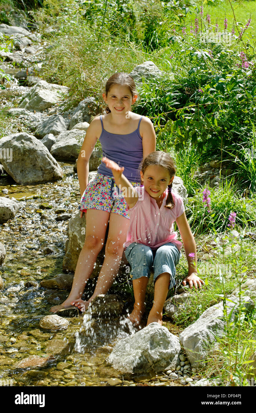 Girls playing and splashing with water, water fight, Kräuter-Erlebnis-Park herb theme park, Bad Heilbrunn, Loisachtal Stock Photo