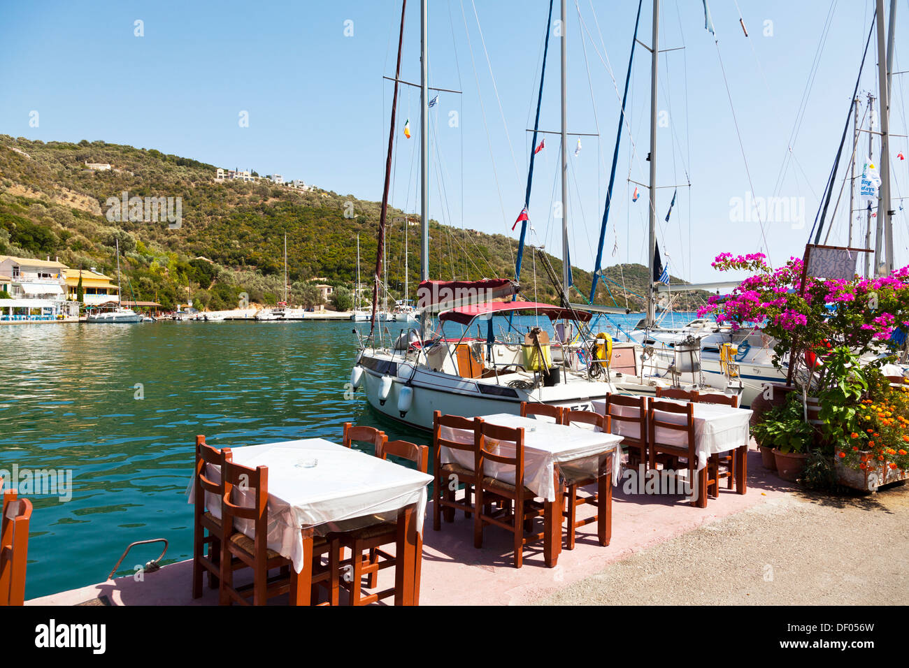 Harbour side taverna tables restaurant next to yachts Sivota village ...