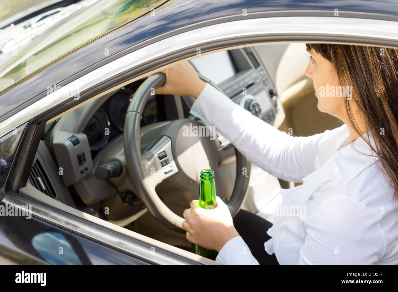 Dangerous Drunk And Inebriated Female Driver Holding Her Her Steering Wheel In One Hand And