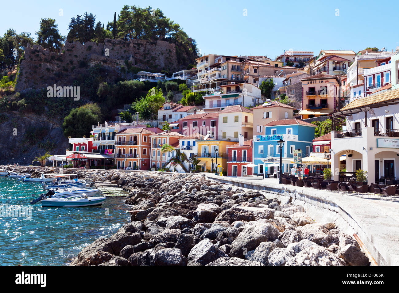 Parga town colourful houses homes tiered castle to left Greek Greece Stock Photo