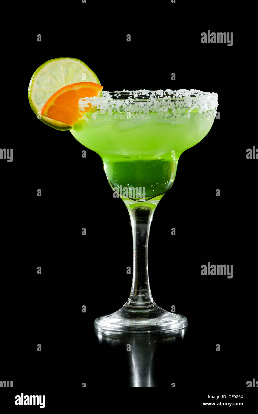 green margarita isolated on a black background served with a thick salt