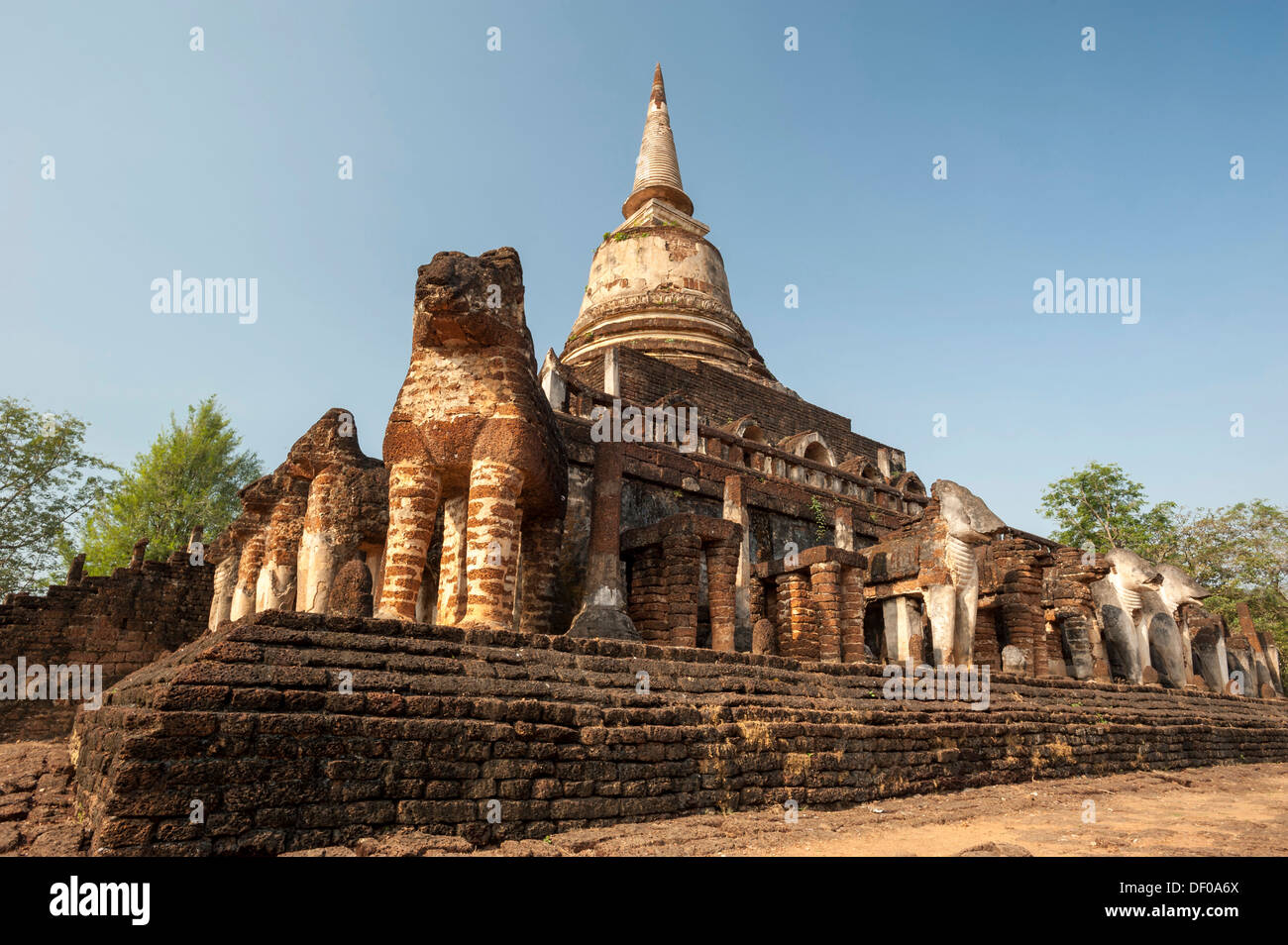 Laterite chedi with destroyed elephant statues, stepped temple of Wat Chang Lom, Si Satchanalai Historical Park Stock Photo