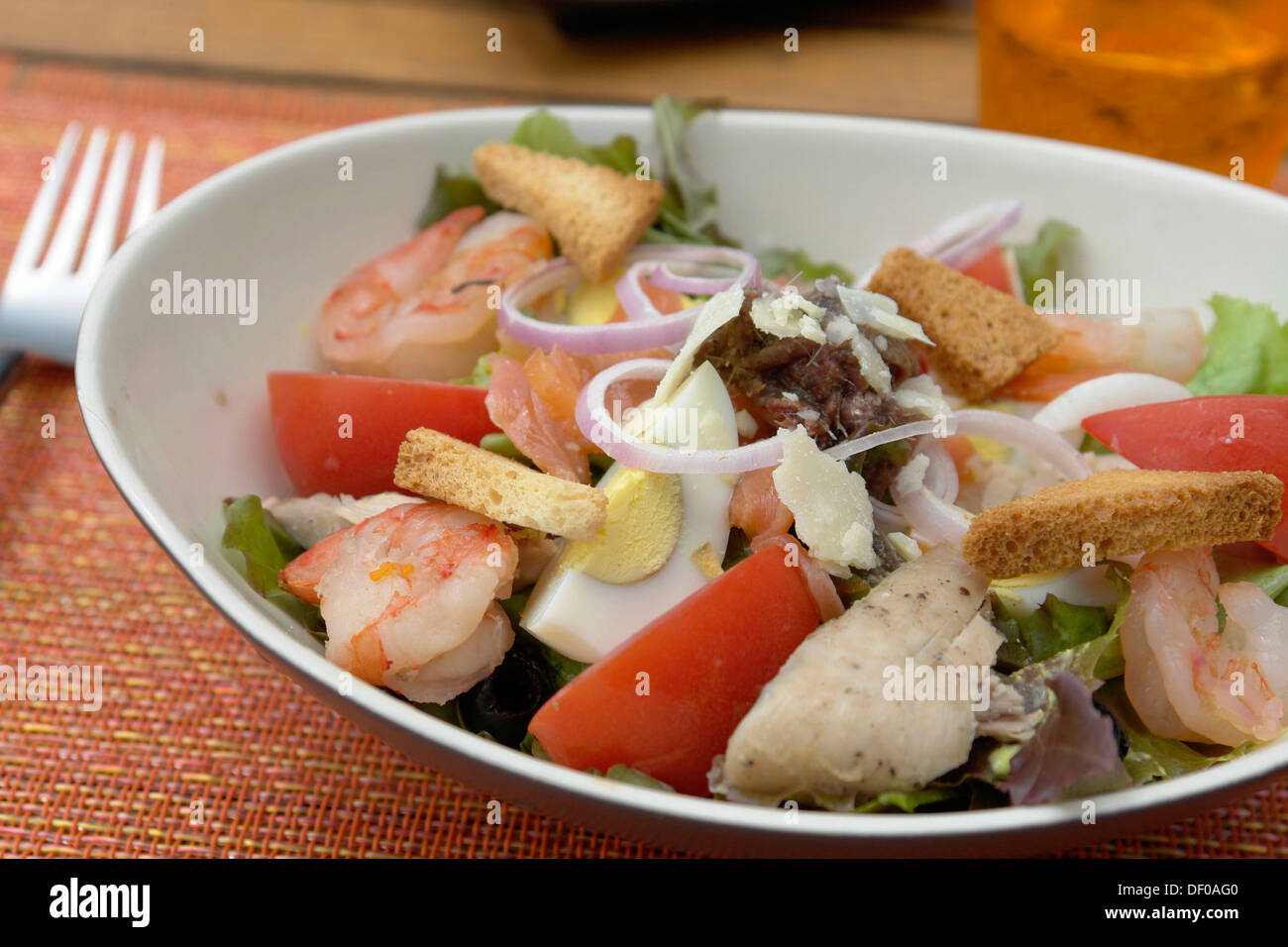 Cesar Salad with lettuce, tuna, anchovies, shrimp, tomato, egg