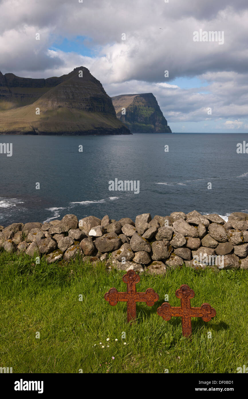 Old rusty grave crosses in a small cemetery by the sea, Vidareidi, Viðareiði, Faroe Islands, Denmark, Northern Europe, Europe Stock Photo