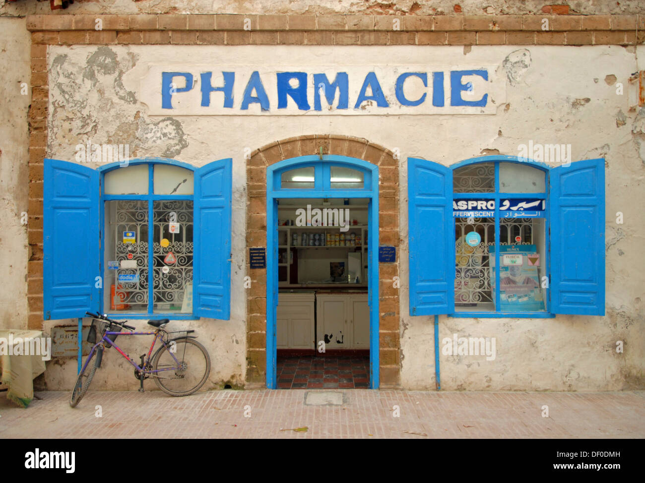 The facade of a pharmacy with a blue door frame and blue window shutters in Essaouira, Morocco, Africa Stock Photo