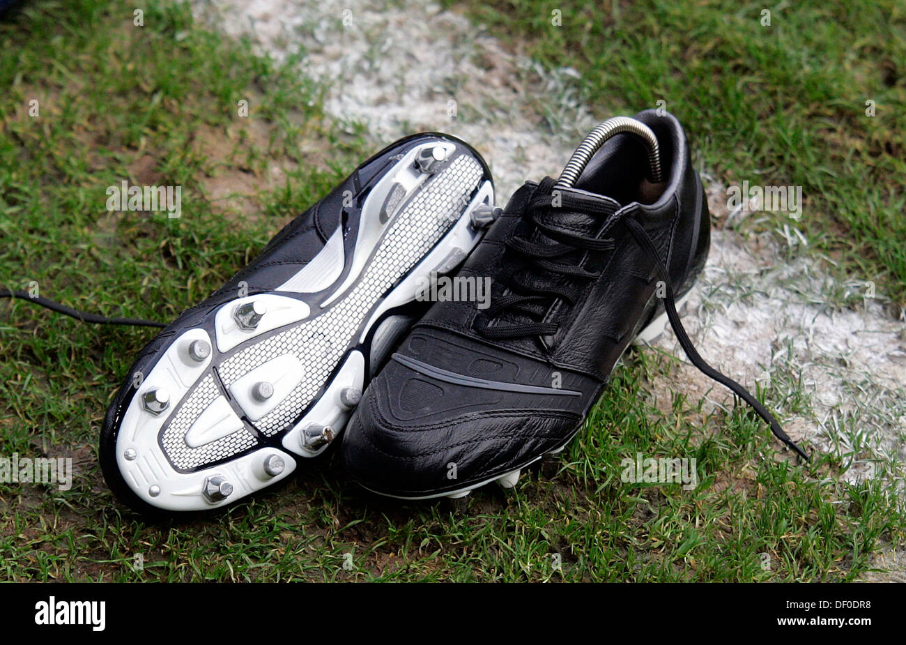 Soccer boots on the football pitch Stock Photo