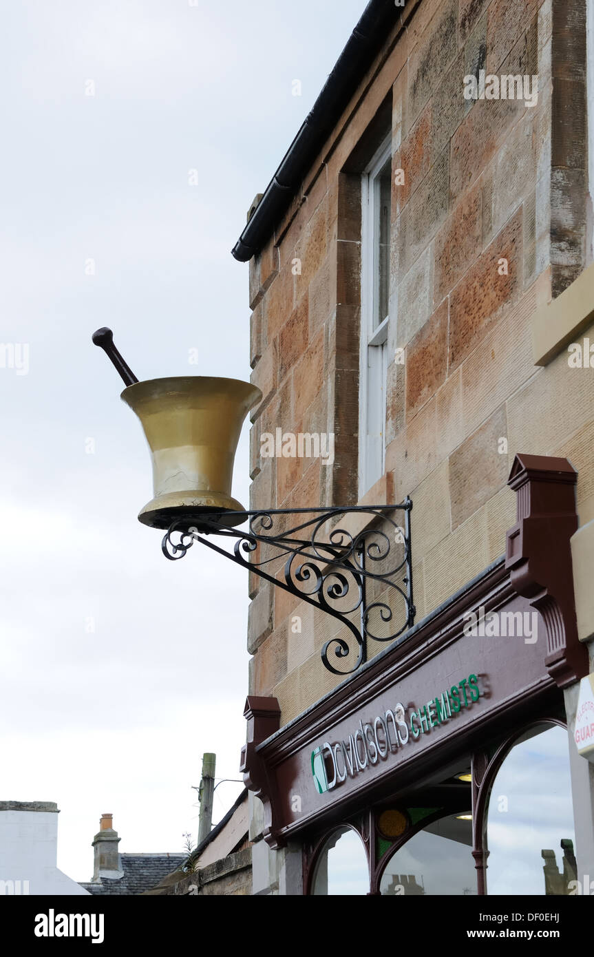 Mortar and pestle above chemist shop Stock Photo