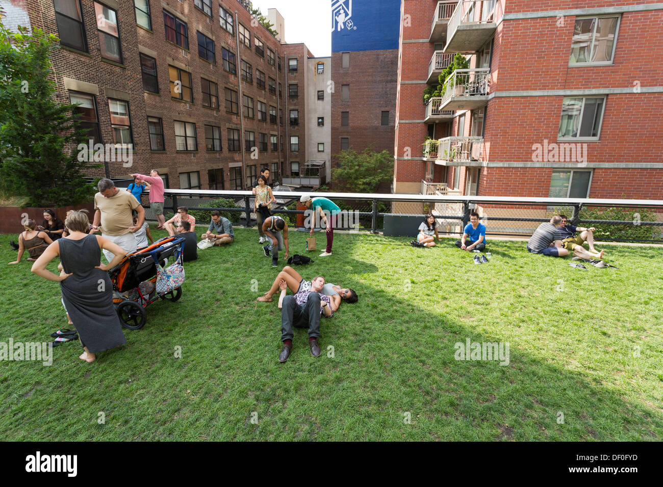 People enjoying a sunny day at the High Line public park elevated above the streets on Manhattan’s West Side Stock Photo