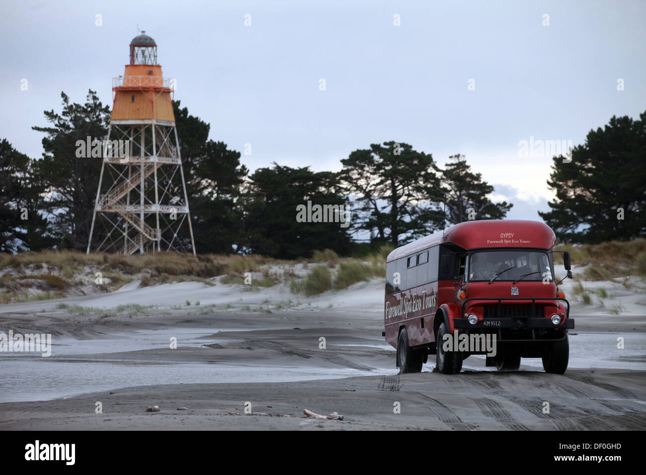 A Farewell Spit Eco Tour bus departs from the lighthouse at the end of the famous sand spit Stock Photo