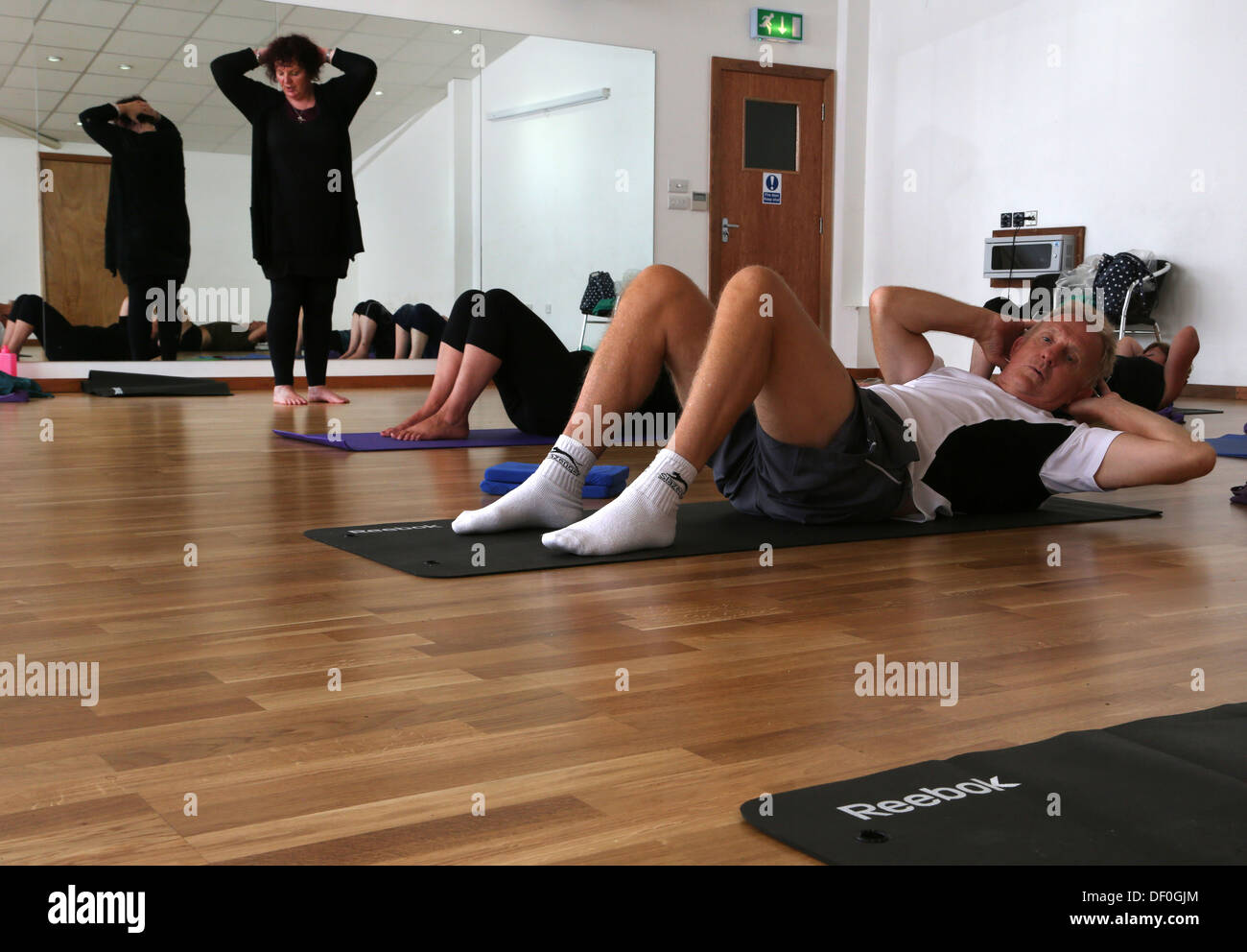 Fitness Instructor Teaching Pilates Physical Fitness Class Stock Photo