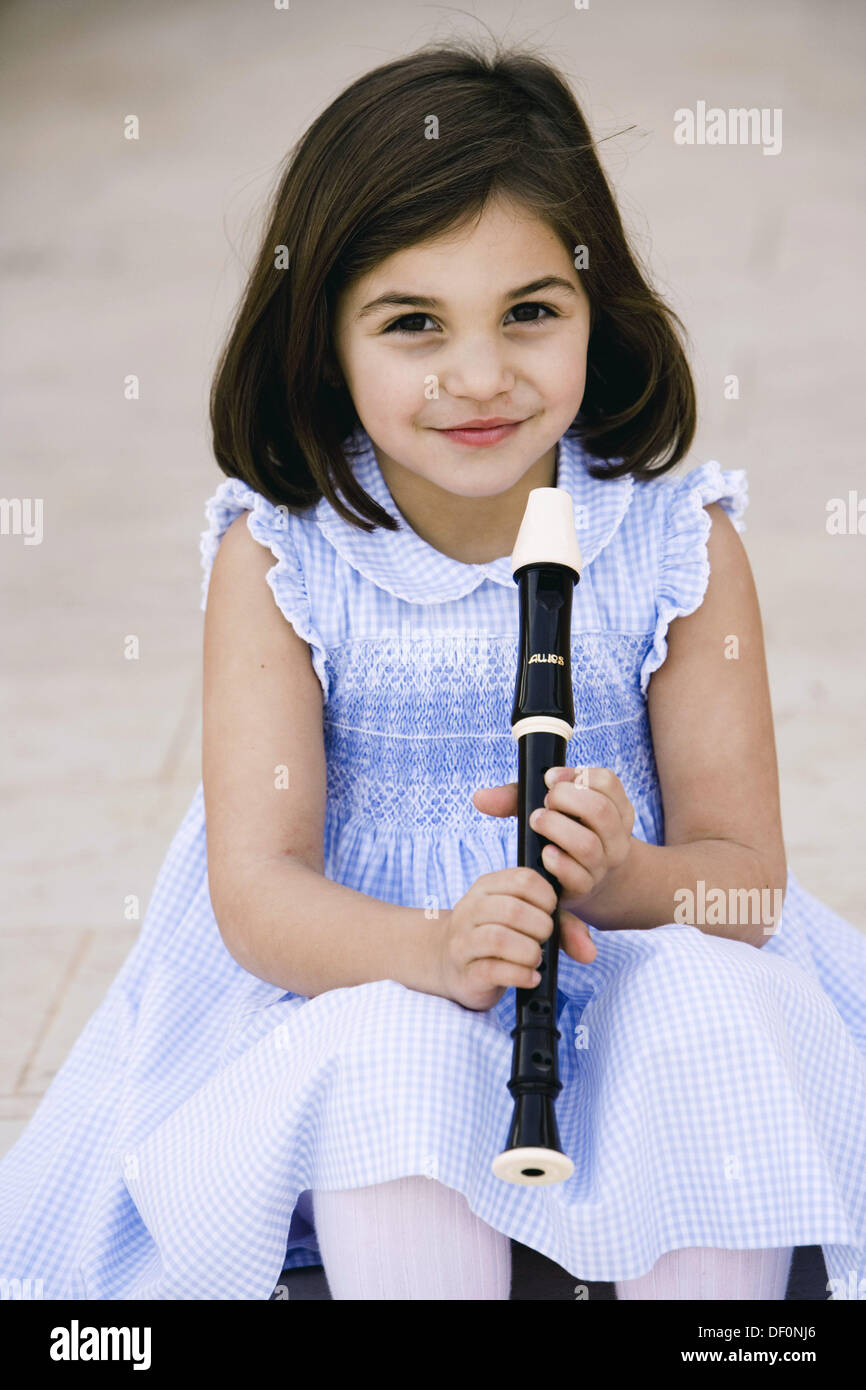 Little girl playing the flute Stock Photo Alamy
